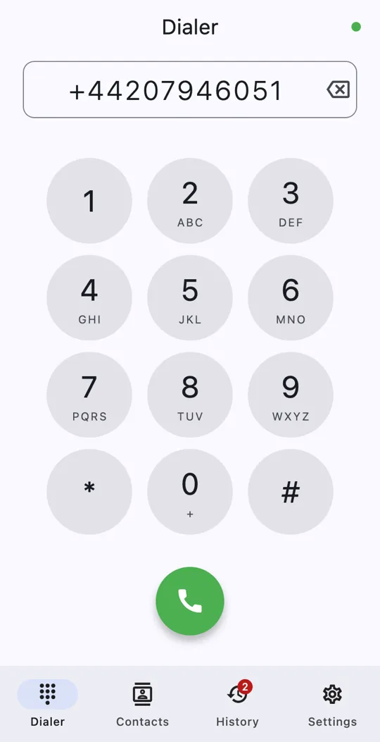 The dialer with a number entered, the keypad and the green call button; the tab bar shows two missed calls on History.
